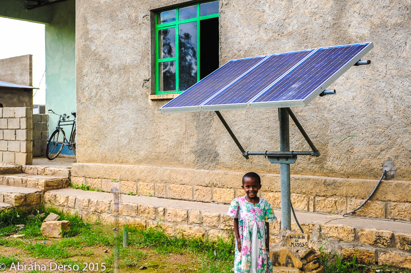 Hildana under solar panels made and installed by students and their teachers from Oakham School, UK 